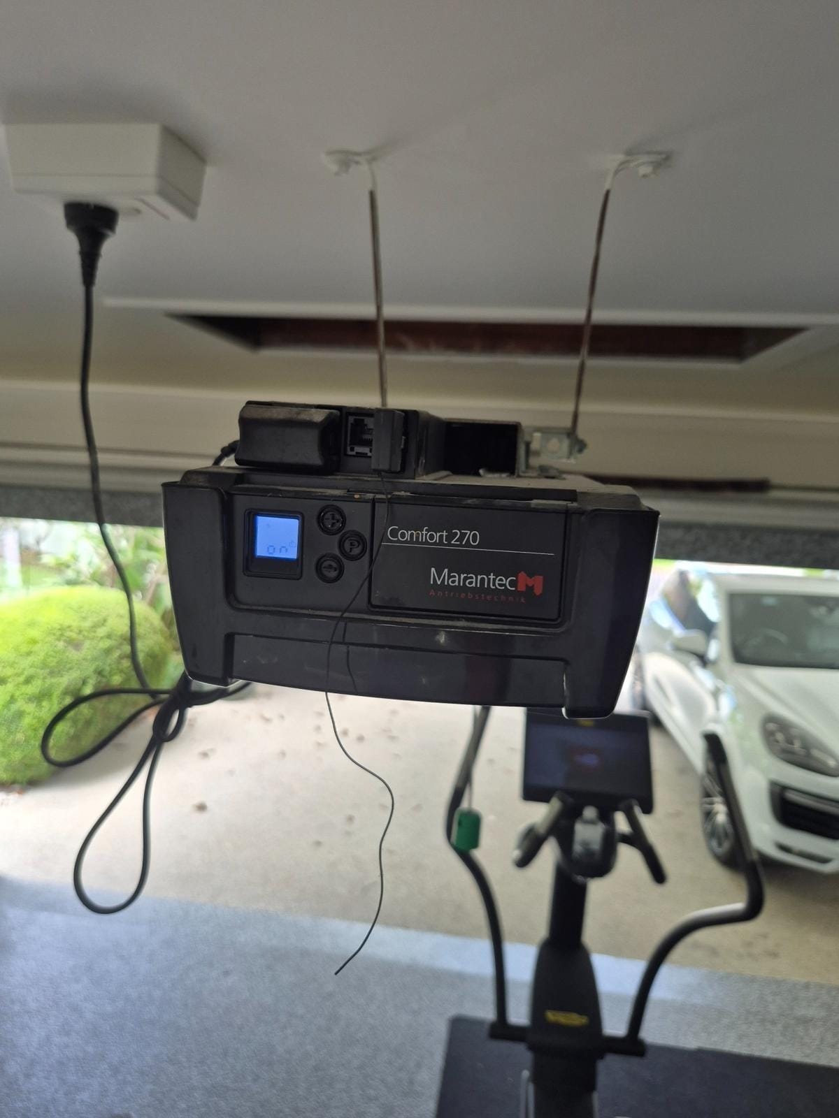 Marantec garage door motor being serviced for remote programming on the Gold Coast